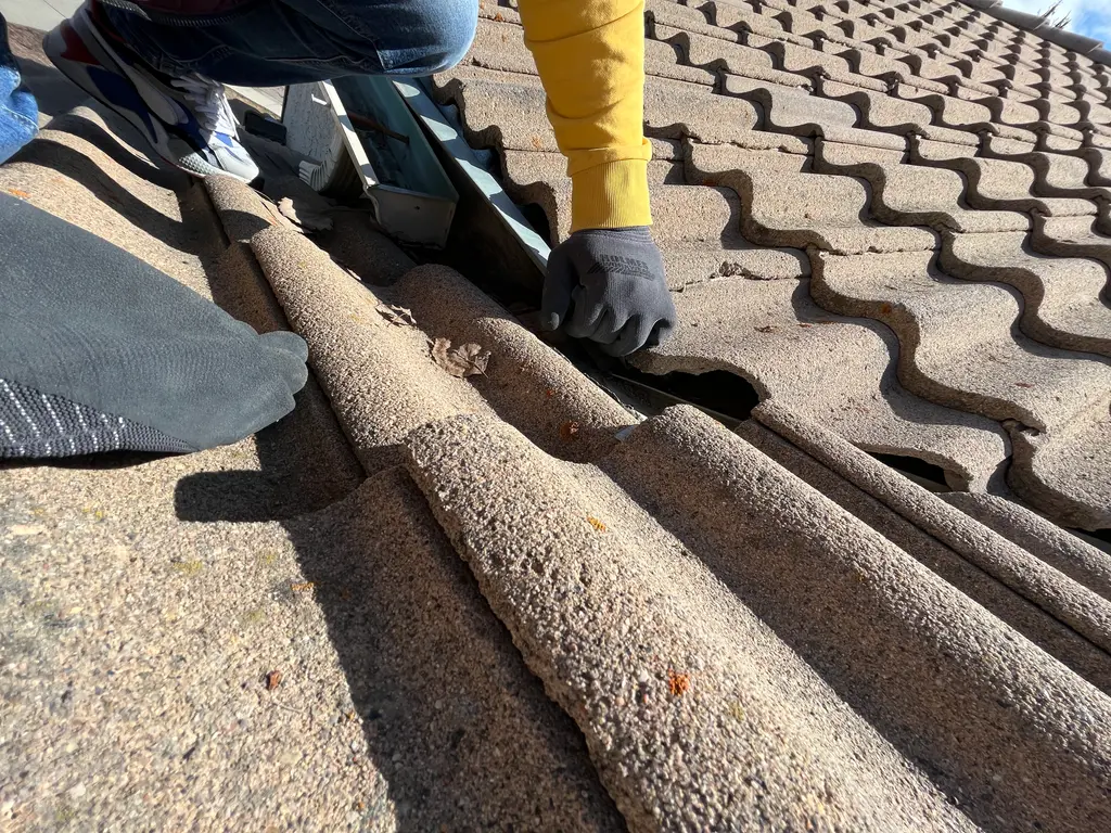Clay roof repair in Calgary, prying under clay tiles