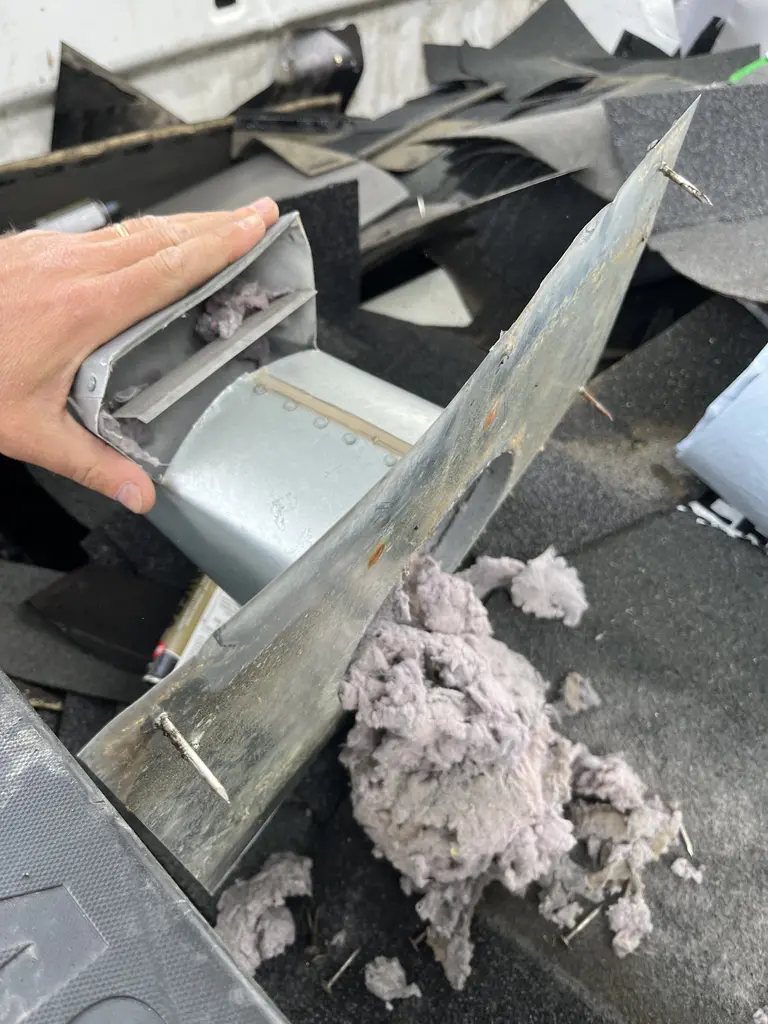 Heavy lint buildup removed from a clogged dryer vent on a Calgary home