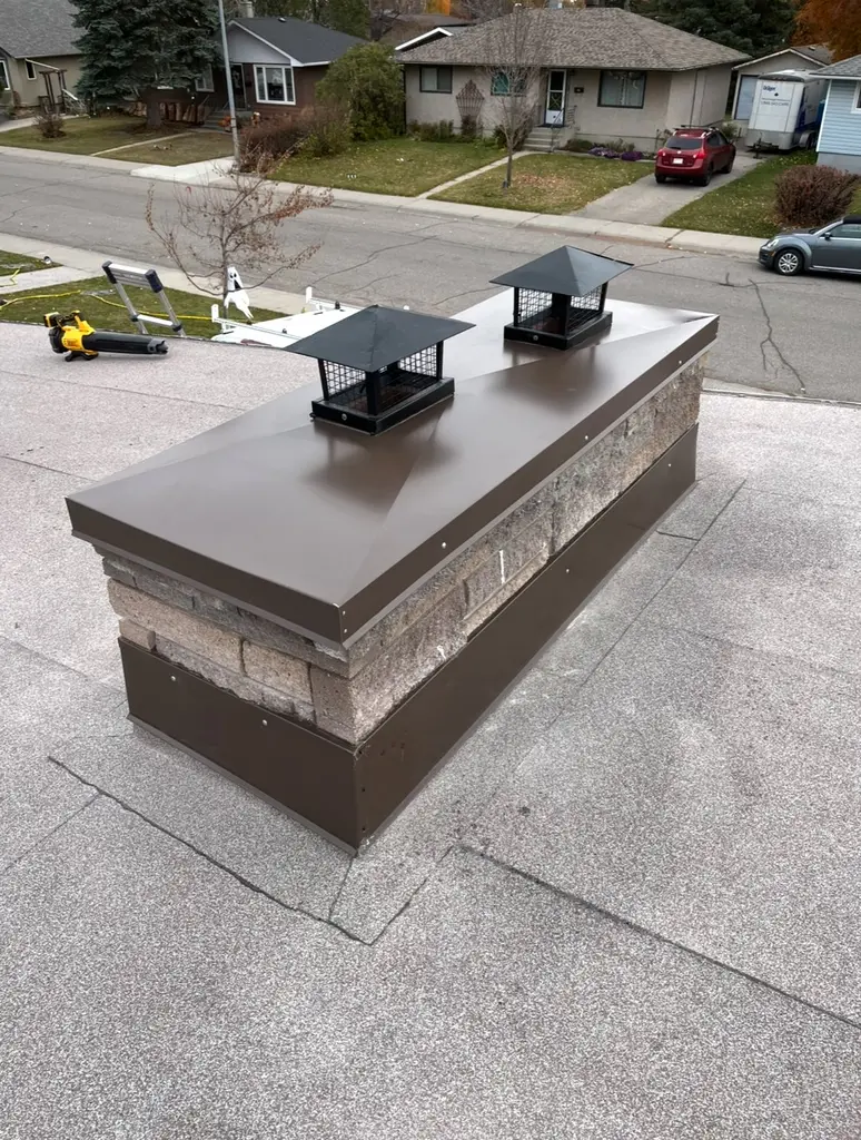 New chimney cap flashing and counter-flashing on a residential flat roof in Calgary