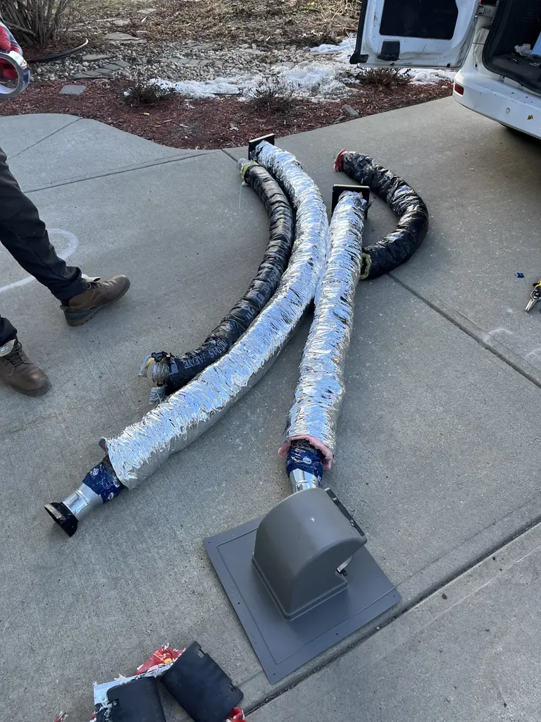 Old flexible ductwork removed during a roof vent replacement in Calgary, 2025