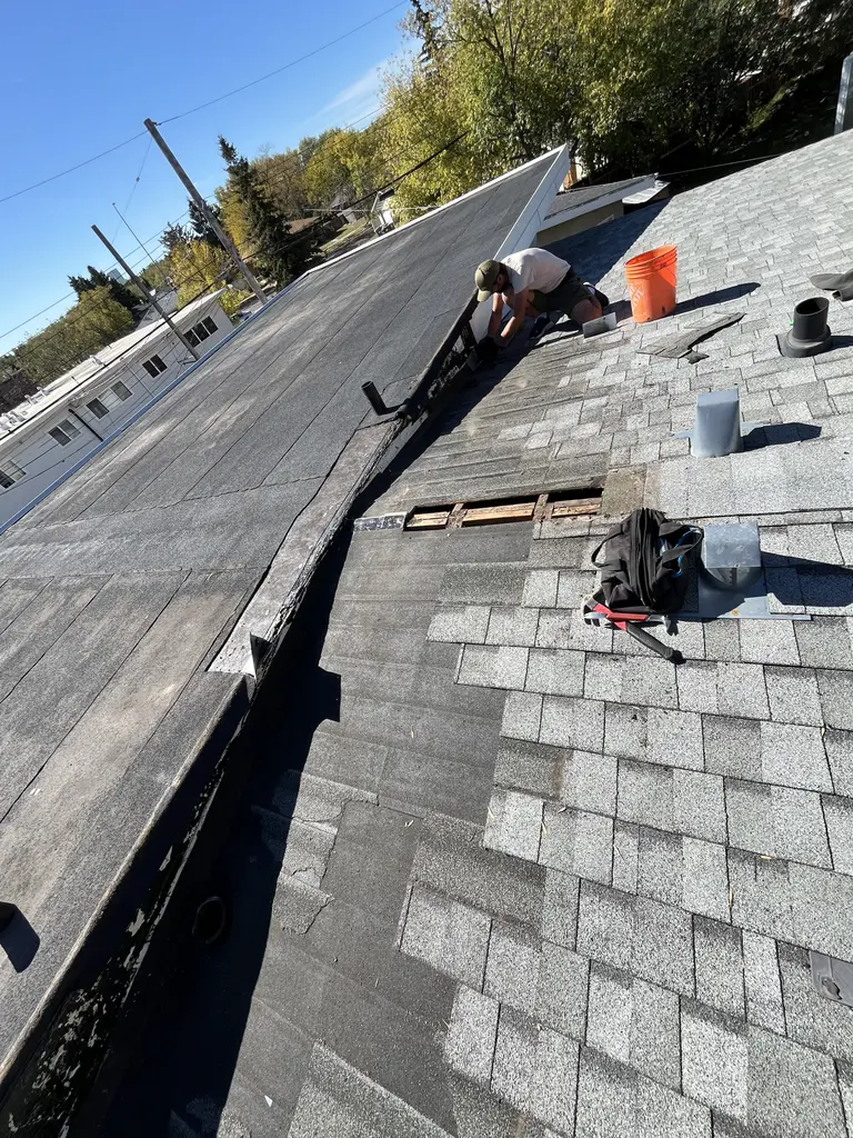Residential flat roof tied in to an asphalt shingle roof in Calgary