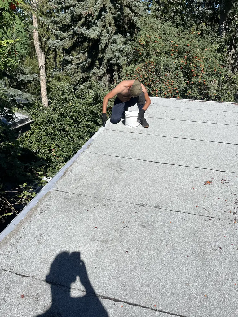 Sokol Preka sealing a flat roof in Calgary, 2025